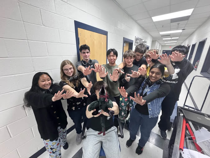 Raptoria members making claw hands in a hallway